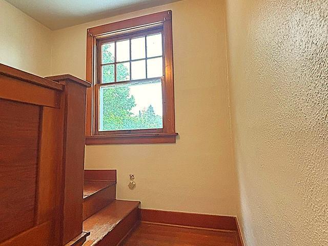 460 E Columbia Ave, Colville, WA 99114 - stairs with baseboards and wood finished floors