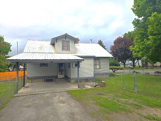 460 E Columbia Ave, Colville, WA 99114 - view of front of property with entry steps, asphalt driveway, an attached carport, and metal roof
