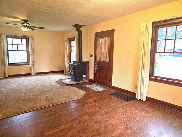 460 E Columbia Ave, Colville, WA 99114 - entrance foyer featuring a wood stove, plenty of natural light, and a textured ceiling