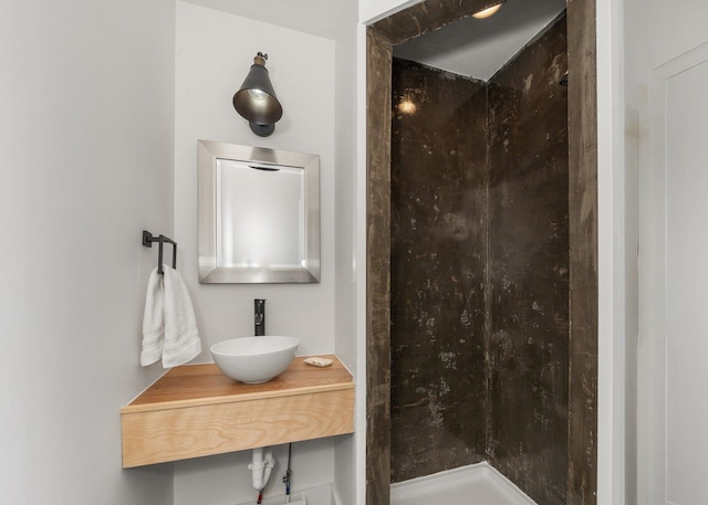 bathroom featuring a sink and a walk in shower