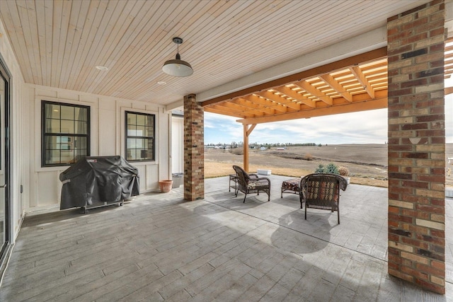 view of patio / terrace featuring a pergola and a grill