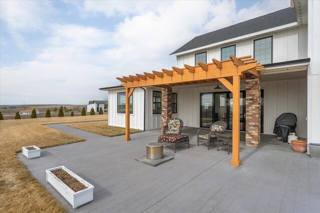 exterior space with a shingled roof, board and batten siding, an outdoor fire pit, and a pergola