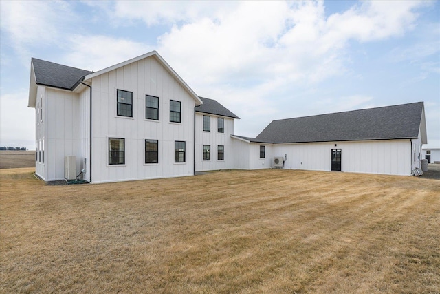 exterior space with a lawn, board and batten siding, and a shingled roof