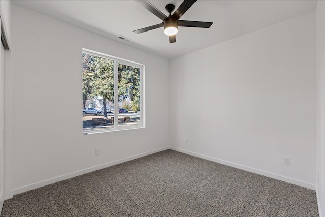 unfurnished room with a ceiling fan, carpet flooring, baseboards, and visible vents