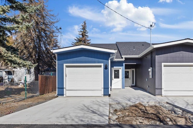 ranch-style house with concrete driveway, an attached garage, fence, and a shingled roof