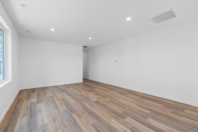 spare room featuring visible vents, recessed lighting, light wood-type flooring, and baseboards