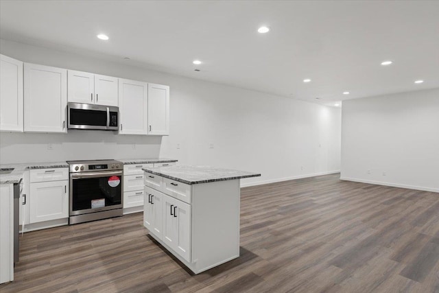 kitchen with recessed lighting, appliances with stainless steel finishes, dark wood-style floors, and white cabinetry