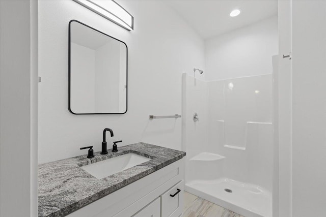 bathroom with vanity and a stall shower