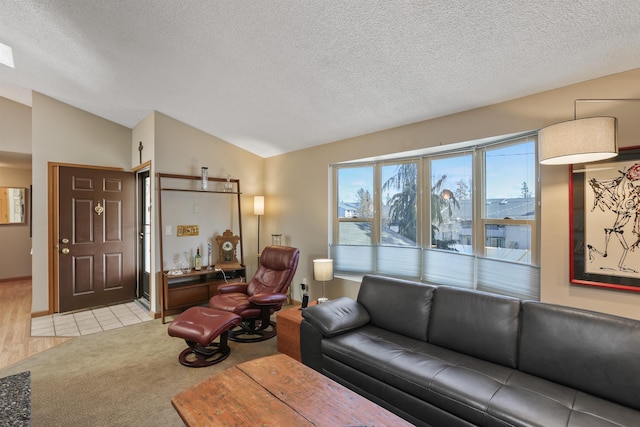 carpeted living area with visible vents, lofted ceiling, and a textured ceiling