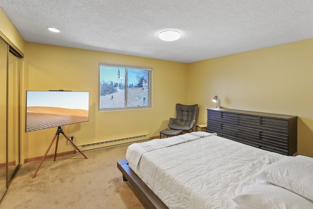 bedroom featuring baseboards, a closet, a textured ceiling, carpet flooring, and baseboard heating