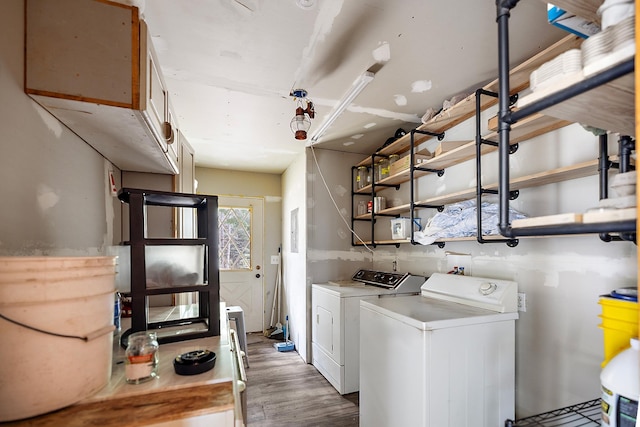 clothes washing area featuring laundry area, light wood-style flooring, and separate washer and dryer