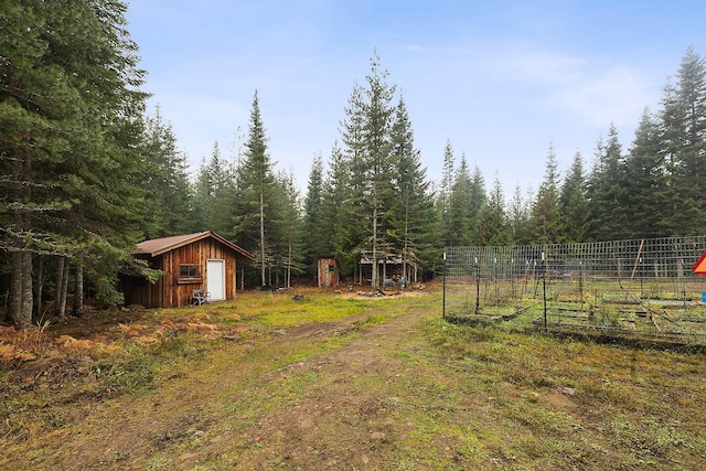 view of yard with a storage unit, a vegetable garden, and an outdoor structure