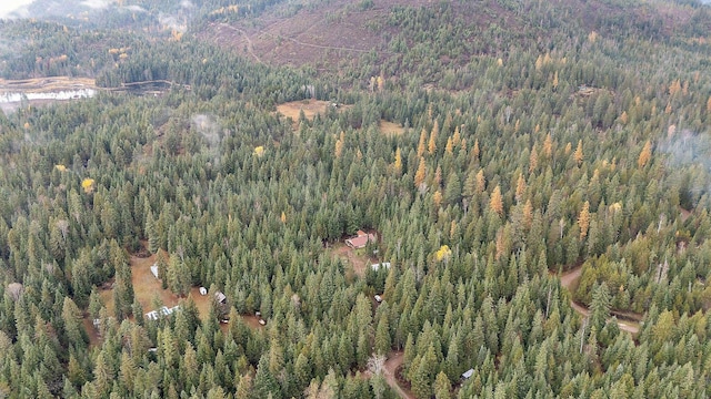 birds eye view of property featuring a view of trees