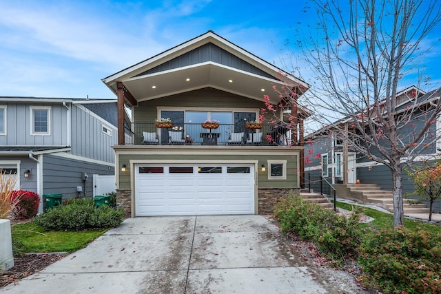 view of front of home featuring concrete driveway, a balcony, and a garage