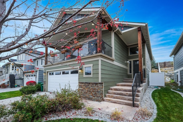 view of front of property featuring concrete driveway, a balcony, and an attached garage