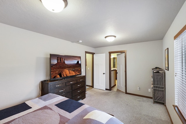 bedroom with baseboards and light colored carpet