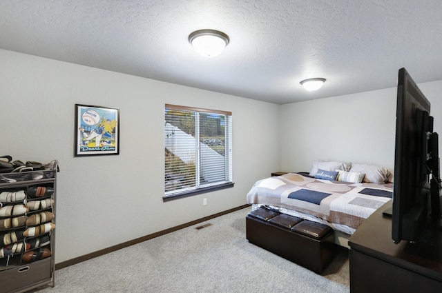 bedroom with visible vents, baseboards, carpet, and a textured ceiling