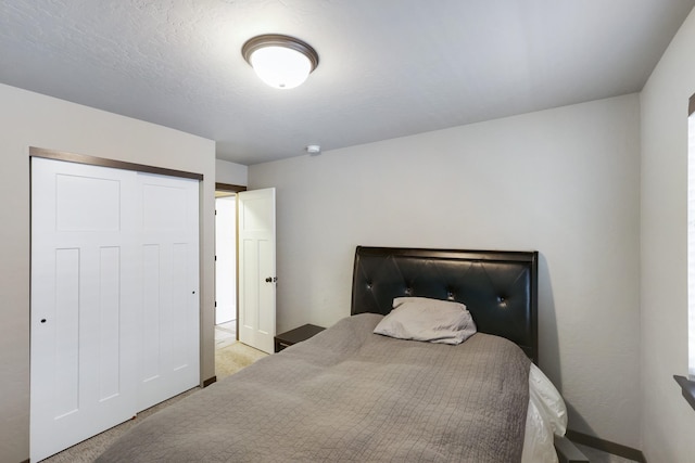 bedroom with a closet and carpet flooring