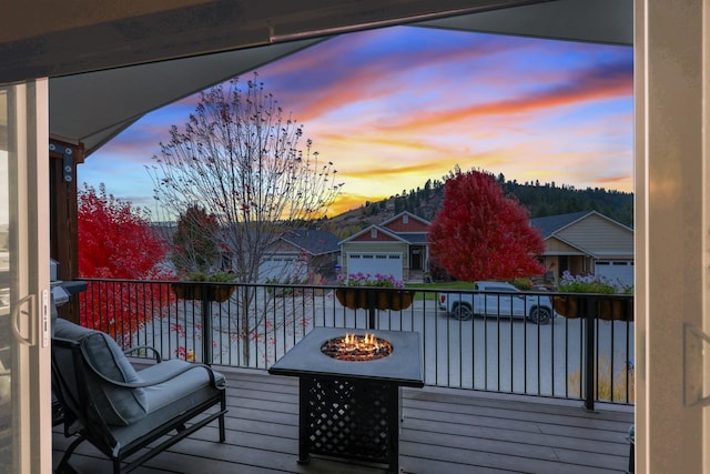 deck at dusk with an outdoor fire pit