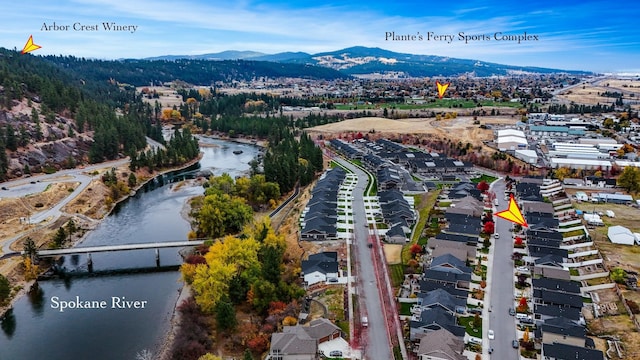 aerial view featuring a water and mountain view