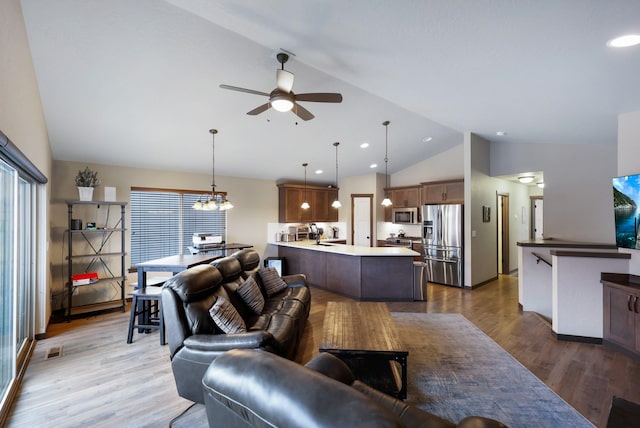 living area featuring a ceiling fan, wood finished floors, visible vents, high vaulted ceiling, and recessed lighting