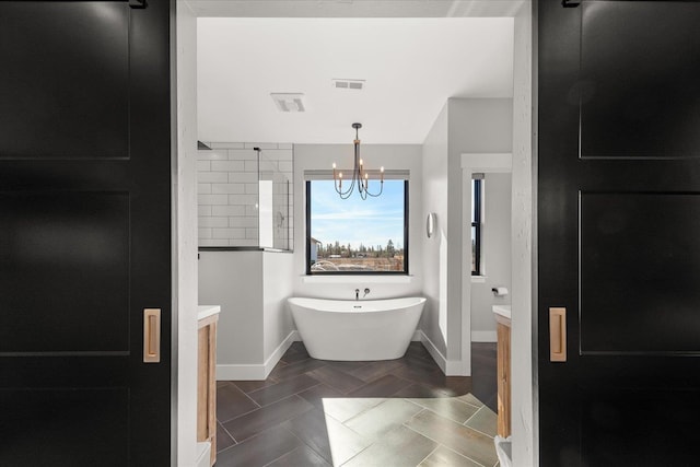 full bath with vanity, visible vents, a chandelier, and a freestanding bath