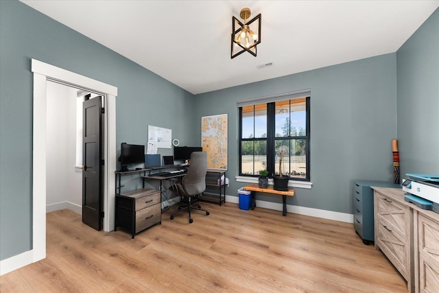 office with light wood-type flooring, baseboards, and visible vents