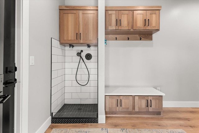 mudroom with light wood-style floors and baseboards