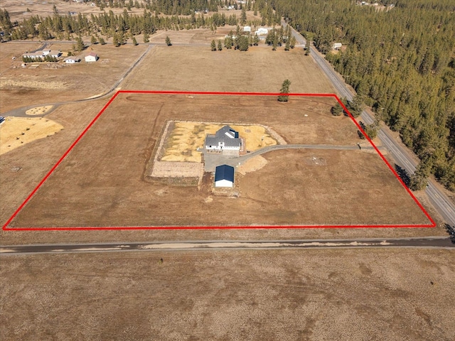 birds eye view of property with a rural view