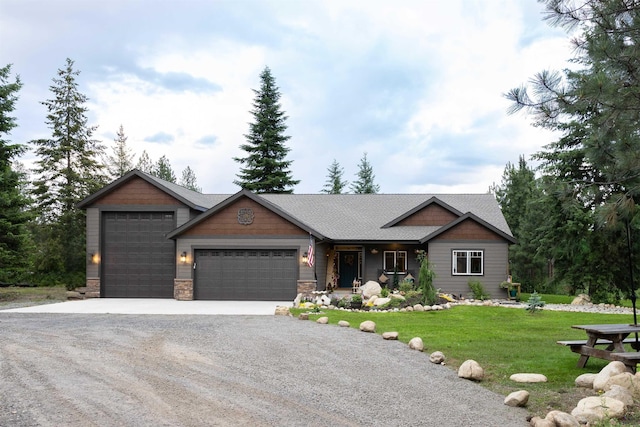 view of front of house with driveway, an attached garage, a shingled roof, a front lawn, and stone siding