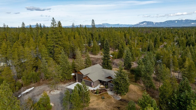 birds eye view of property featuring a forest view and a mountain view