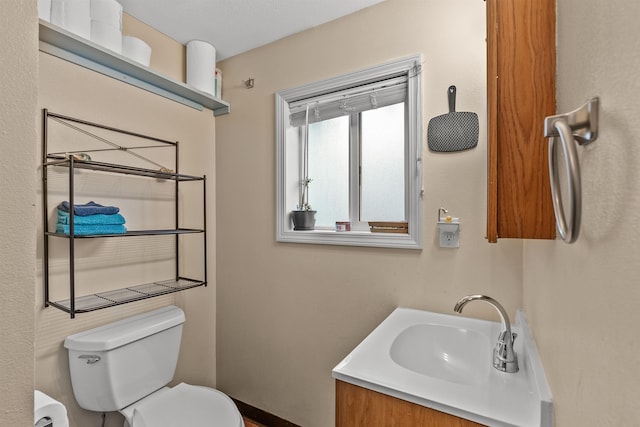 bathroom featuring toilet and vanity