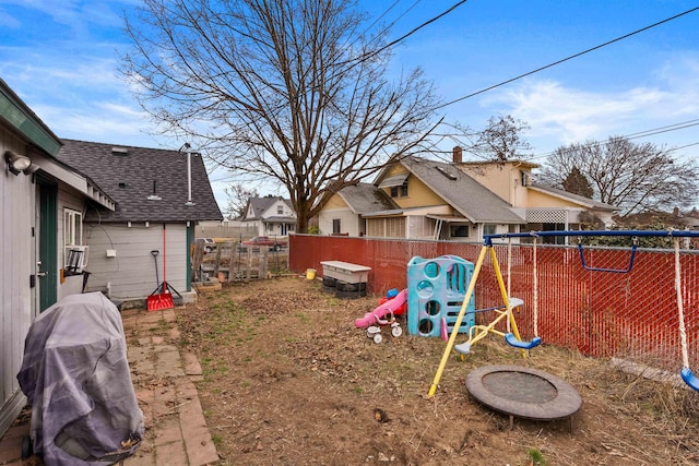 view of yard with fence and a playground