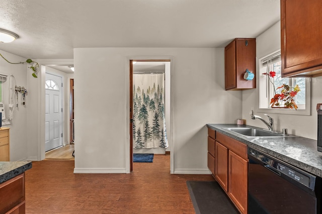 kitchen featuring a sink, brown cabinets, black dishwasher, and dark wood-style floors