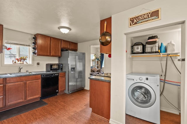 kitchen with a sink, washer / clothes dryer, wood finished floors, stainless steel fridge, and dishwasher