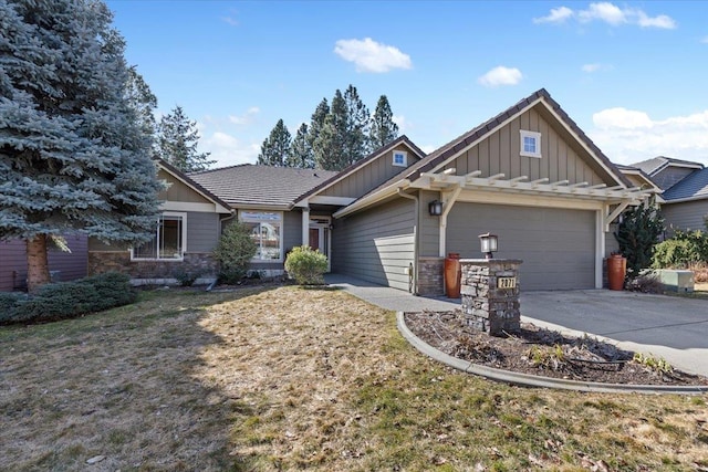 craftsman inspired home featuring stone siding, board and batten siding, concrete driveway, and a garage