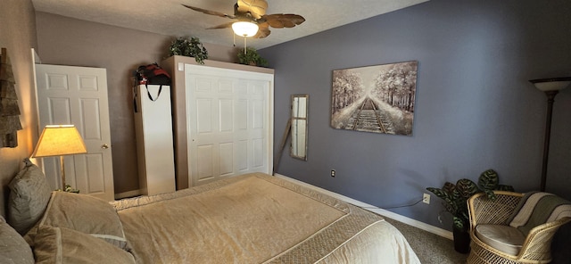 carpeted bedroom with ceiling fan, a textured ceiling, and baseboards