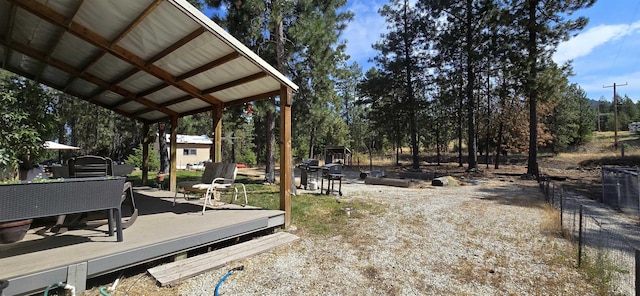 view of yard with a carport and a wooden deck