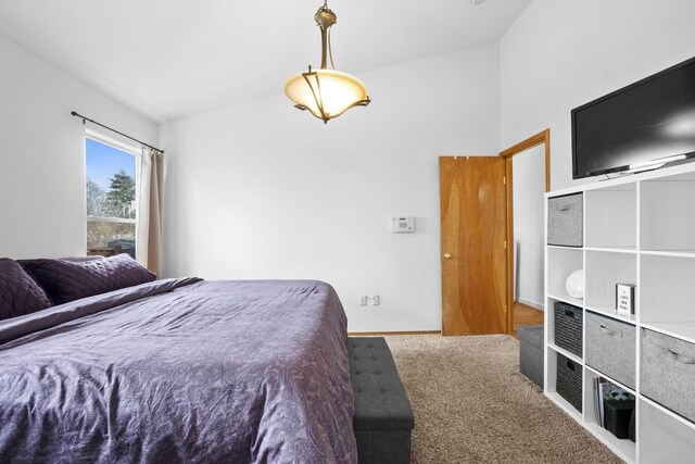 bedroom featuring carpet floors and lofted ceiling