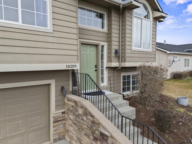 view of exterior entry featuring a garage