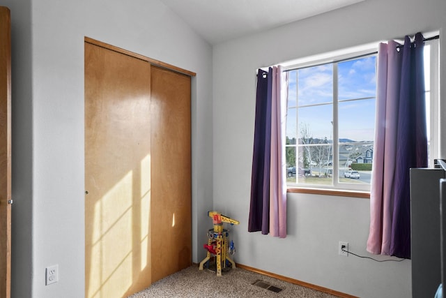 carpeted bedroom featuring baseboards and visible vents