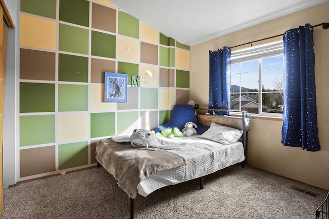 bedroom with lofted ceiling, visible vents, and carpet floors