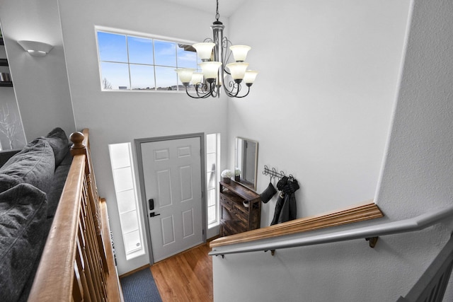 entrance foyer with a notable chandelier and wood finished floors