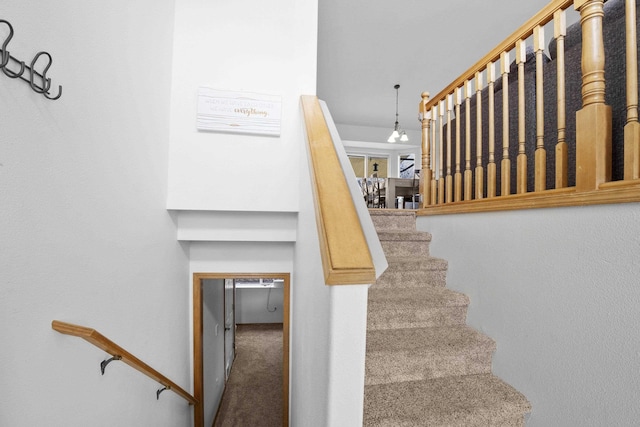 stairway featuring carpet flooring