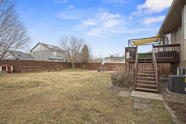 view of yard with central air condition unit, a wooden deck, stairs, and a fenced backyard