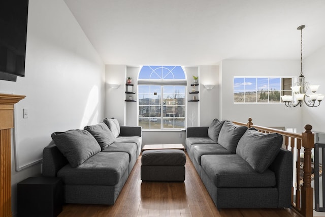 living room with a notable chandelier and wood finished floors