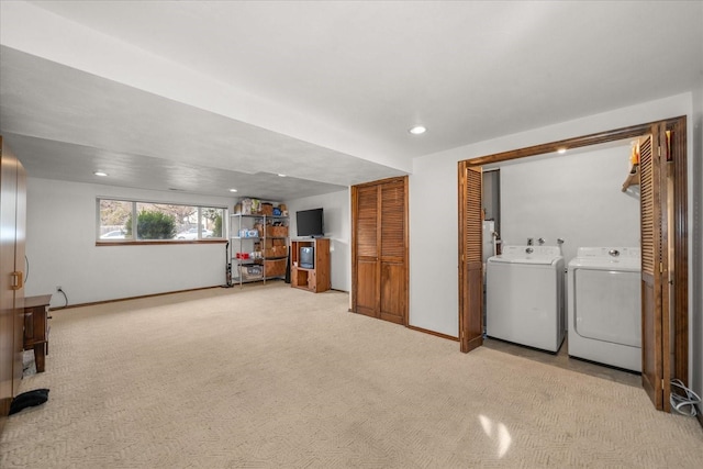 below grade area with recessed lighting, baseboards, light colored carpet, and washing machine and dryer