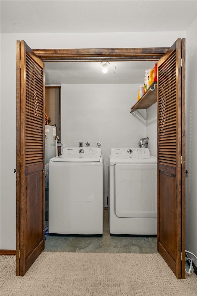 washroom featuring washer and clothes dryer, laundry area, and water heater