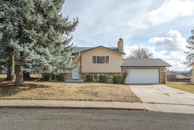 view of front of house featuring driveway, a chimney, an attached garage, and a front yard