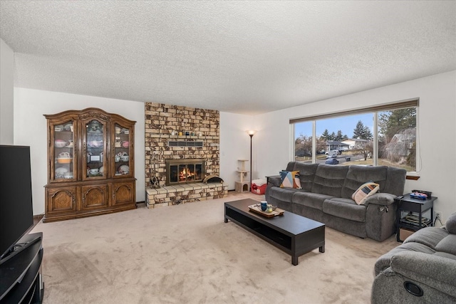 carpeted living area featuring a fireplace and a textured ceiling